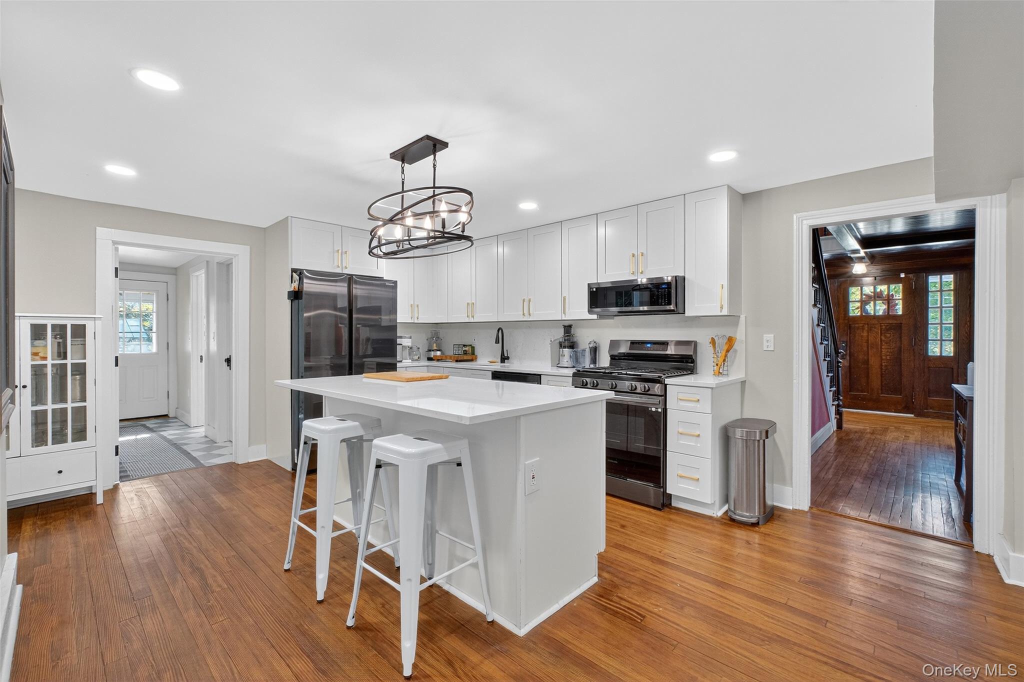 30 Old Post Road North Red Hook, NY 12571 - Photo 13 of 39 a kitchen with stainless steel appliances granite countertop a refrigerator a stove top oven a sink dishwasher a dining table and chairs with wooden floor