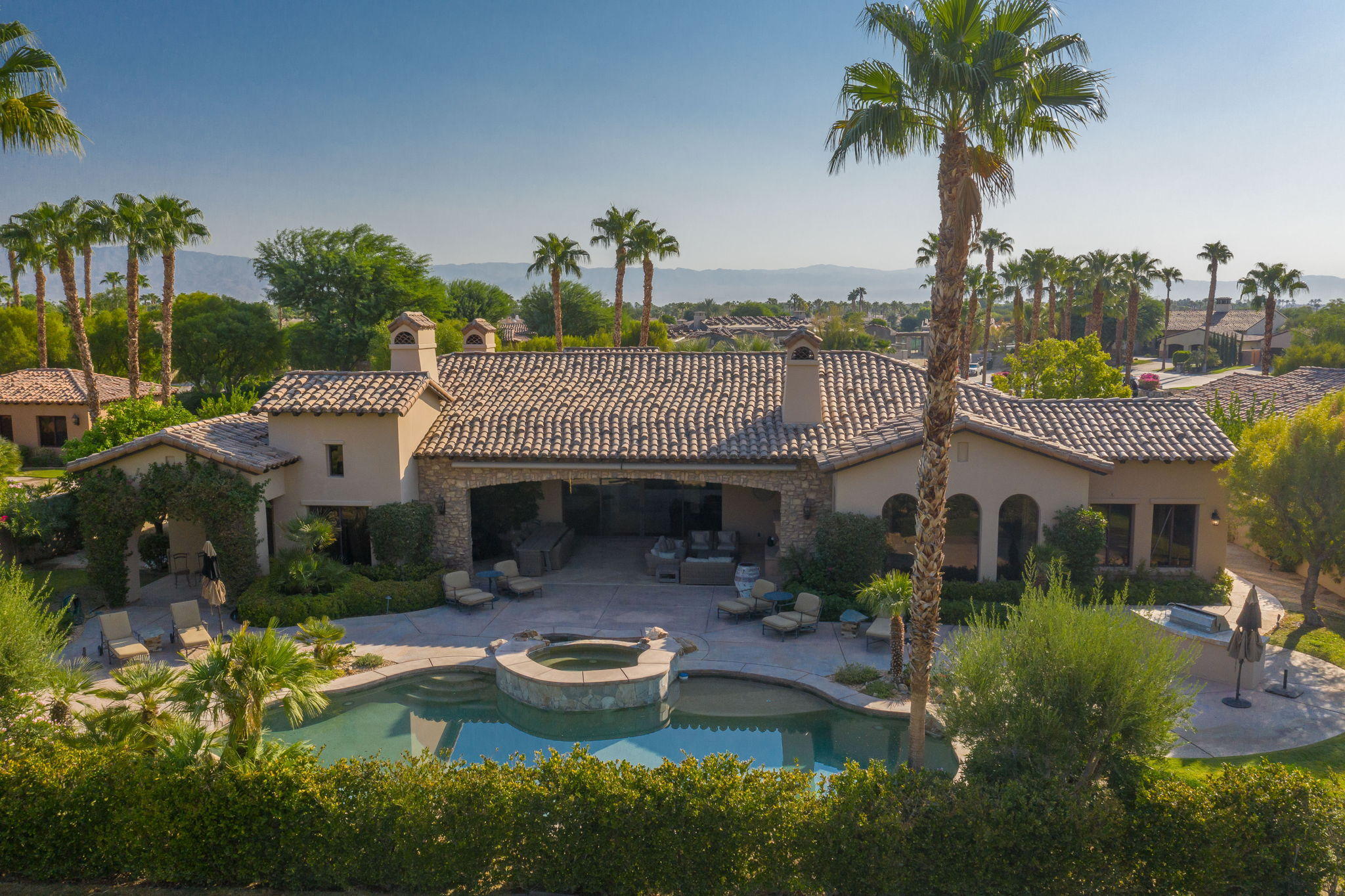 57325 Peninsula Lane La Quinta, CA 92253 - Photo 13 of 66 a front view of a house with garden and plants