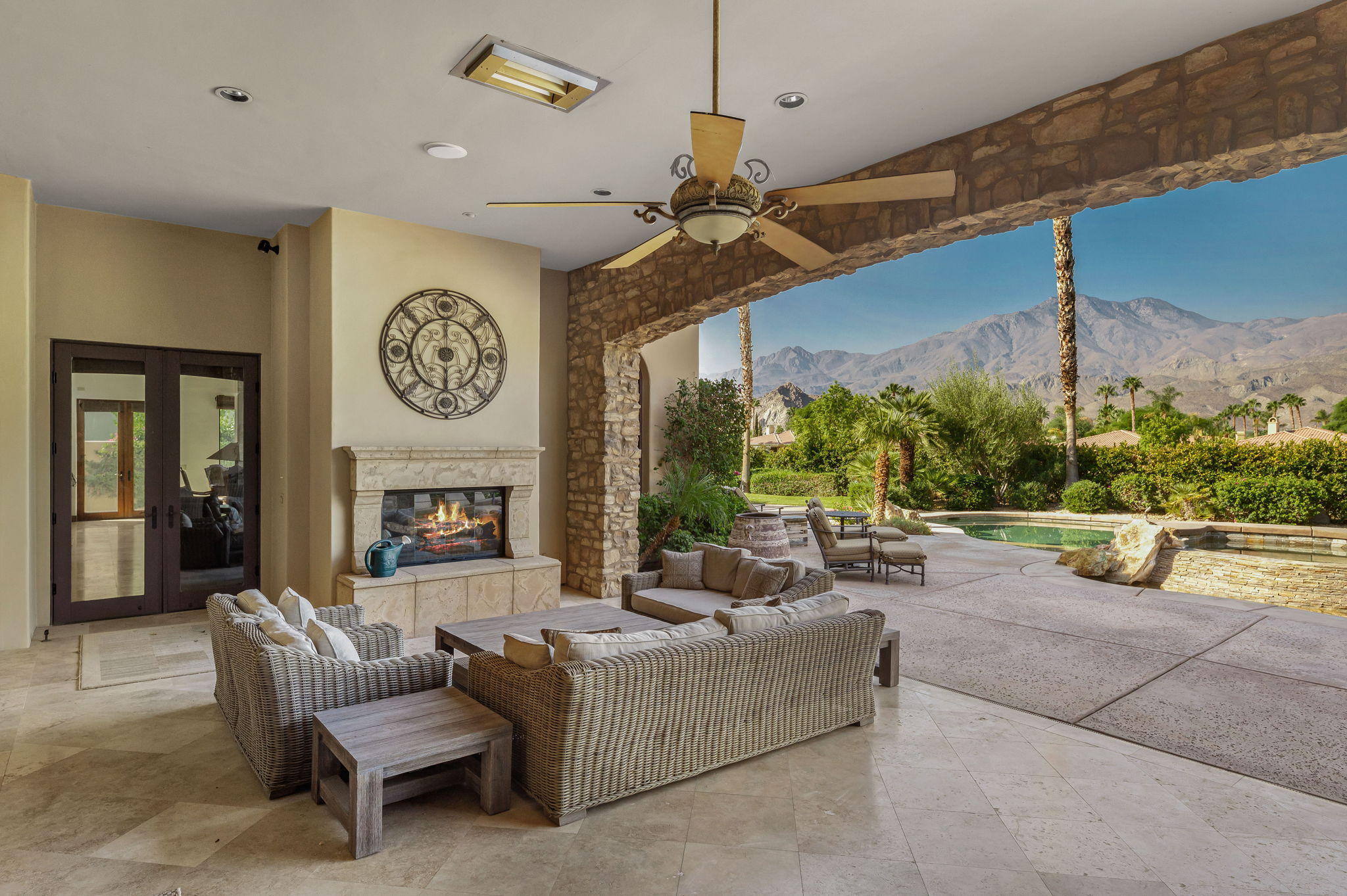 57325 Peninsula Lane La Quinta, CA 92253 - Photo 21 of 66 a living room with furniture a fireplace and a large window