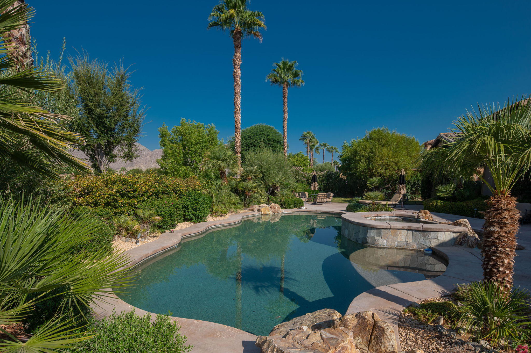 57325 Peninsula Lane La Quinta, CA 92253 - Photo 31 of 66 a swimming pool with outdoor seating and yard