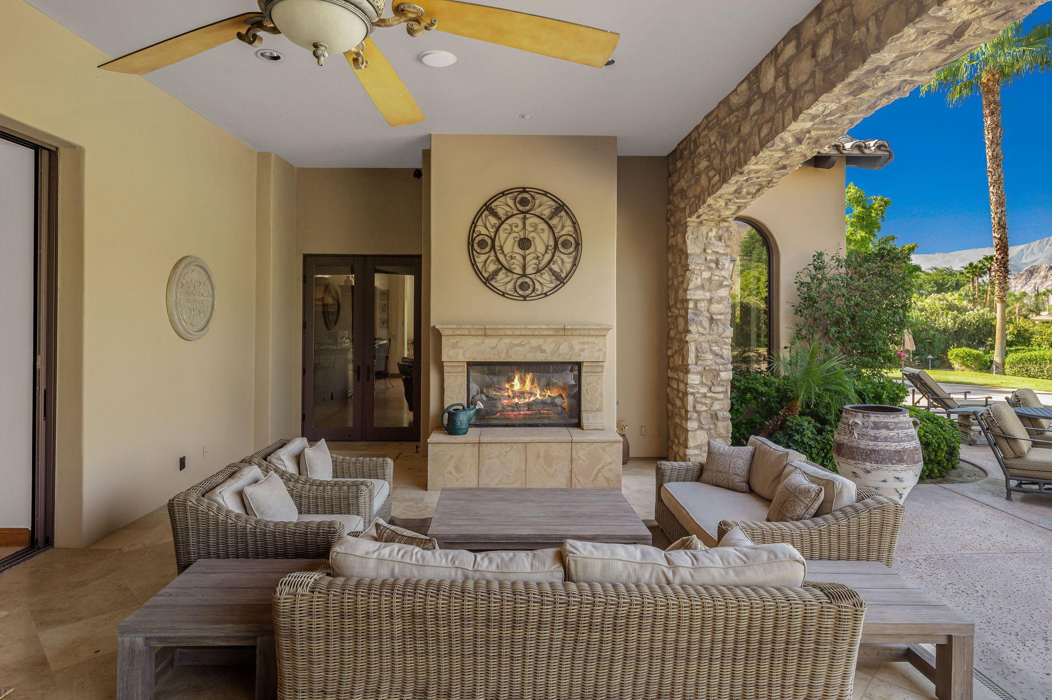 57325 Peninsula Lane La Quinta, CA 92253 - Photo 36 of 66 a living room with furniture a clock and a fireplace