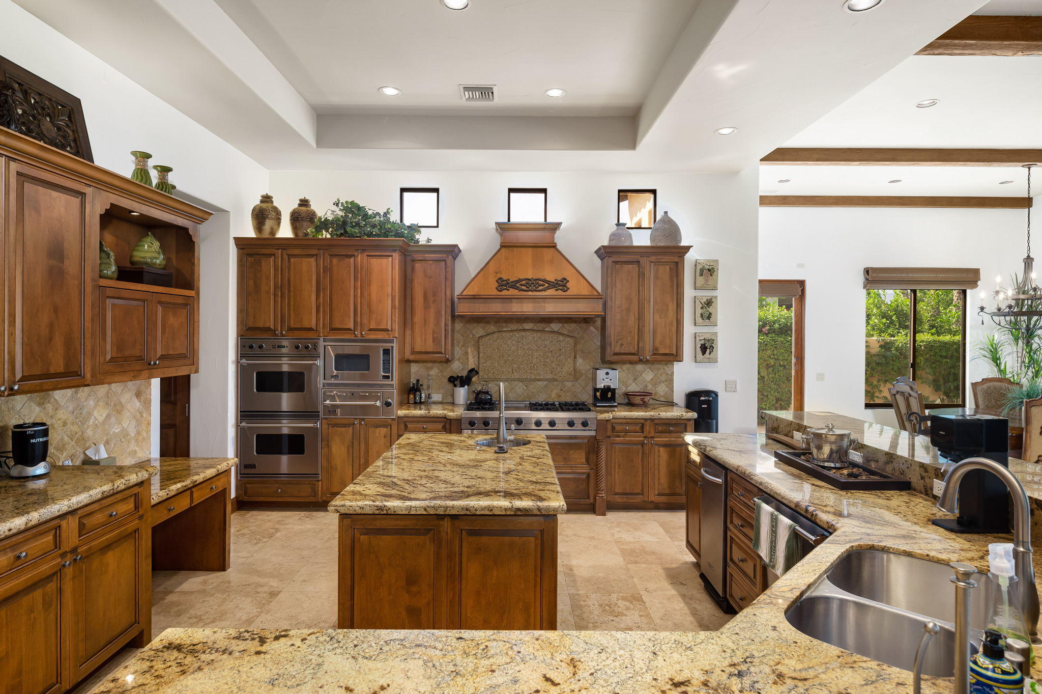 57325 Peninsula Lane La Quinta, CA 92253 - Photo 41 of 66 a kitchen with stainless steel appliances granite countertop a stove sink and cabinets