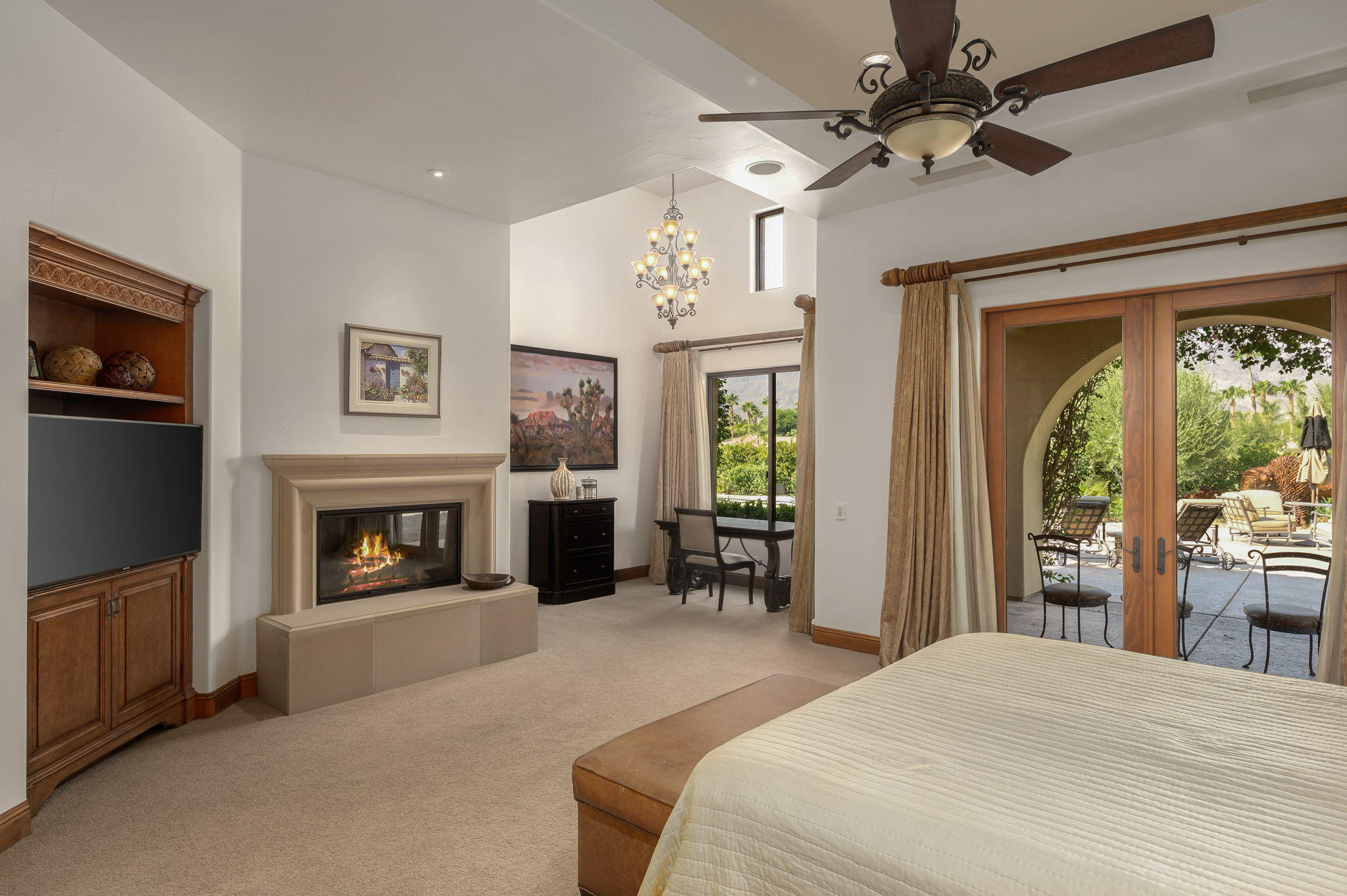 57325 Peninsula Lane La Quinta, CA 92253 - Photo 52 of 66 a bedroom with a bed and a fireplace
