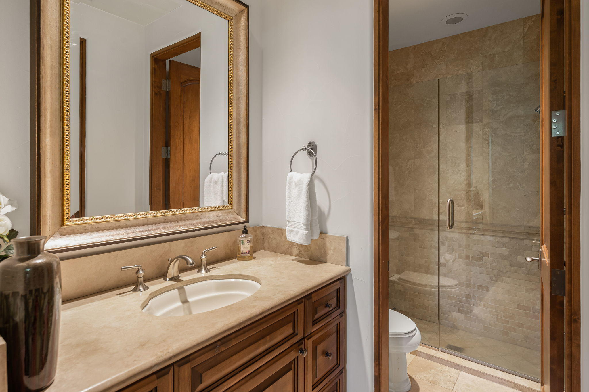 57325 Peninsula Lane La Quinta, CA 92253 - Photo 59 of 66 a bathroom with a granite countertop sink a mirror and shower