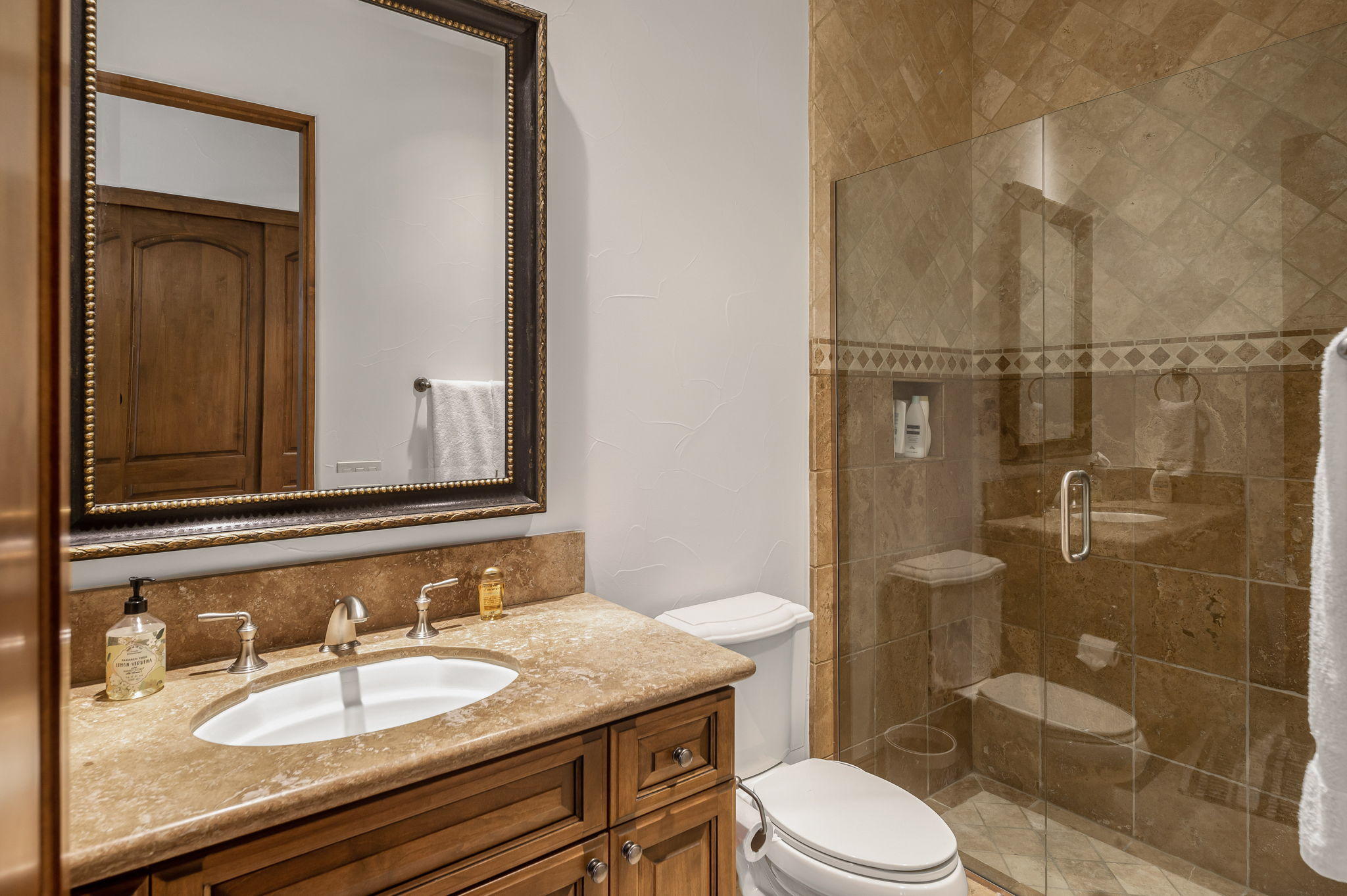 57325 Peninsula Lane La Quinta, CA 92253 - Photo 61 of 66 a bathroom with a granite countertop sink toilet a mirror and shower