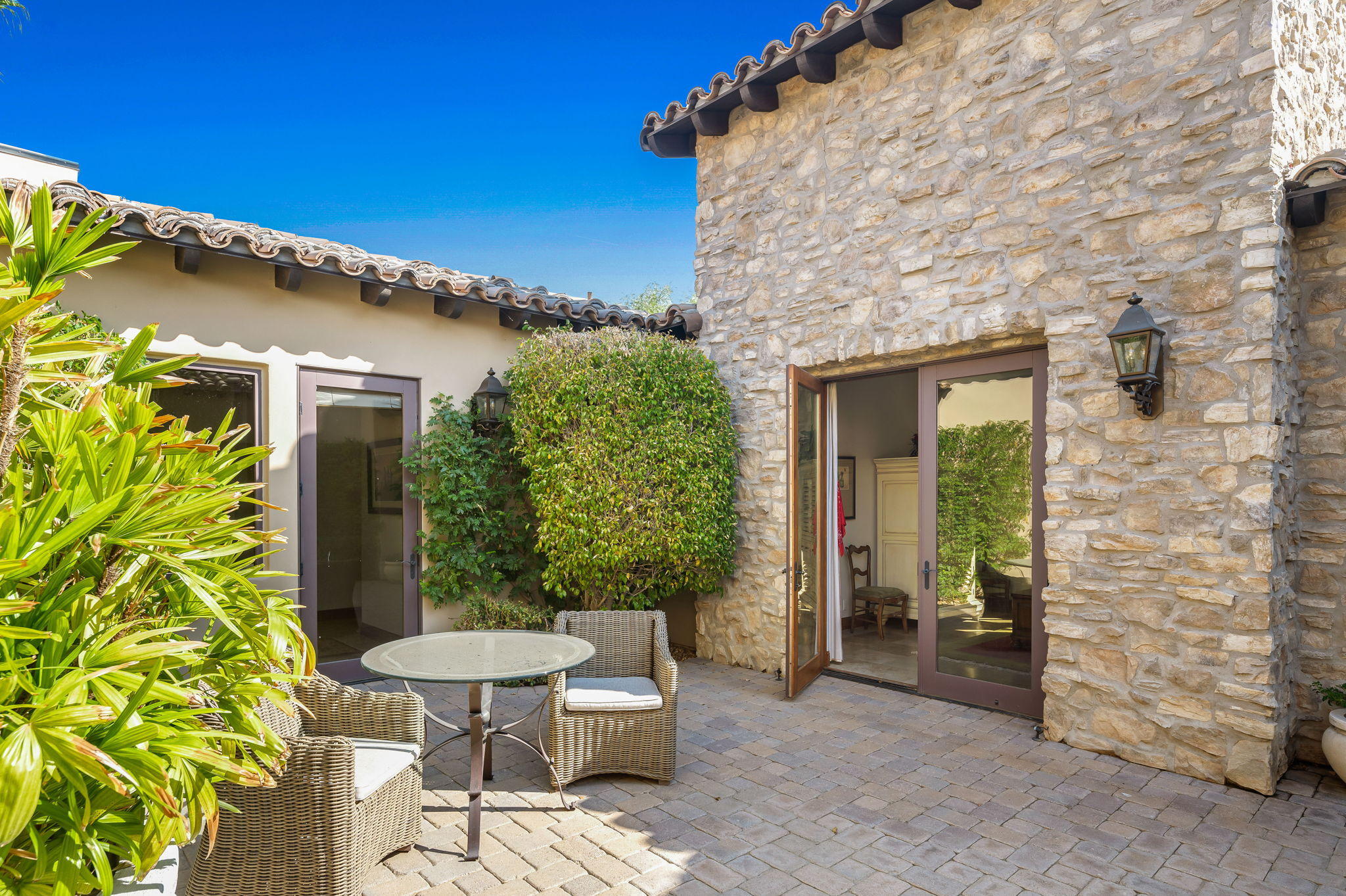 57325 Peninsula Lane La Quinta, CA 92253 - Photo 63 of 66 a view of a patio with table and chairs and potted plants