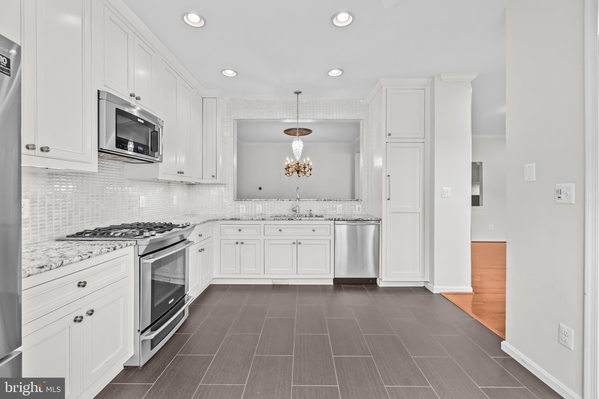 20366 Cloverfield Terrace Sterling, VA 20165 - Photo 11 of 96 a kitchen with stainless steel appliances granite countertop a stove a sink and a microwave