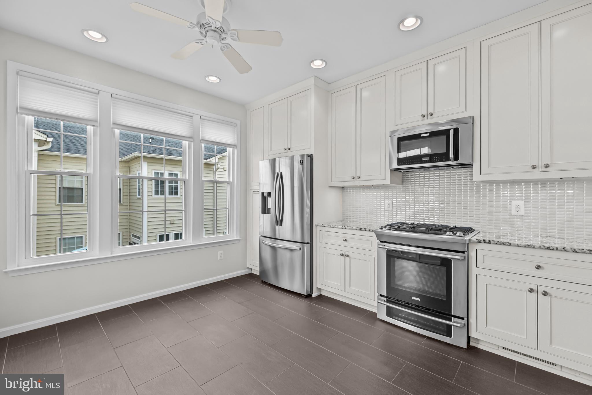 20366 Cloverfield Terrace Sterling, VA 20165 - Photo 12 of 96 a kitchen with stainless steel appliances granite countertop a stove and a refrigerator