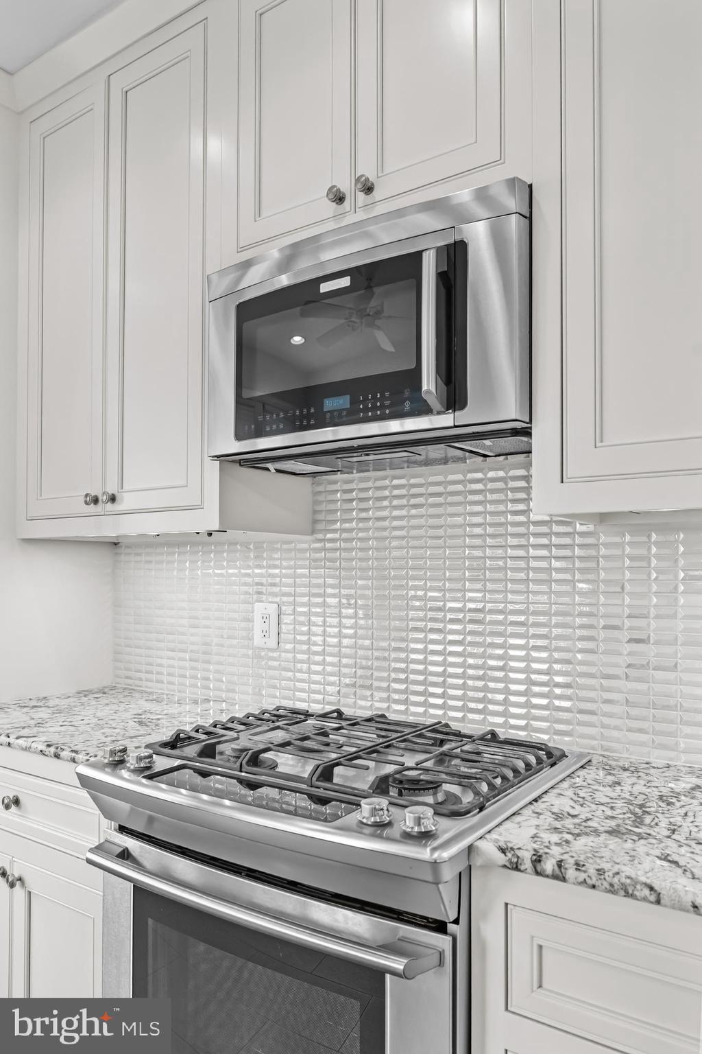 20366 Cloverfield Terrace Sterling, VA 20165 - Photo 14 of 96 a stove top oven sitting inside of a kitchen