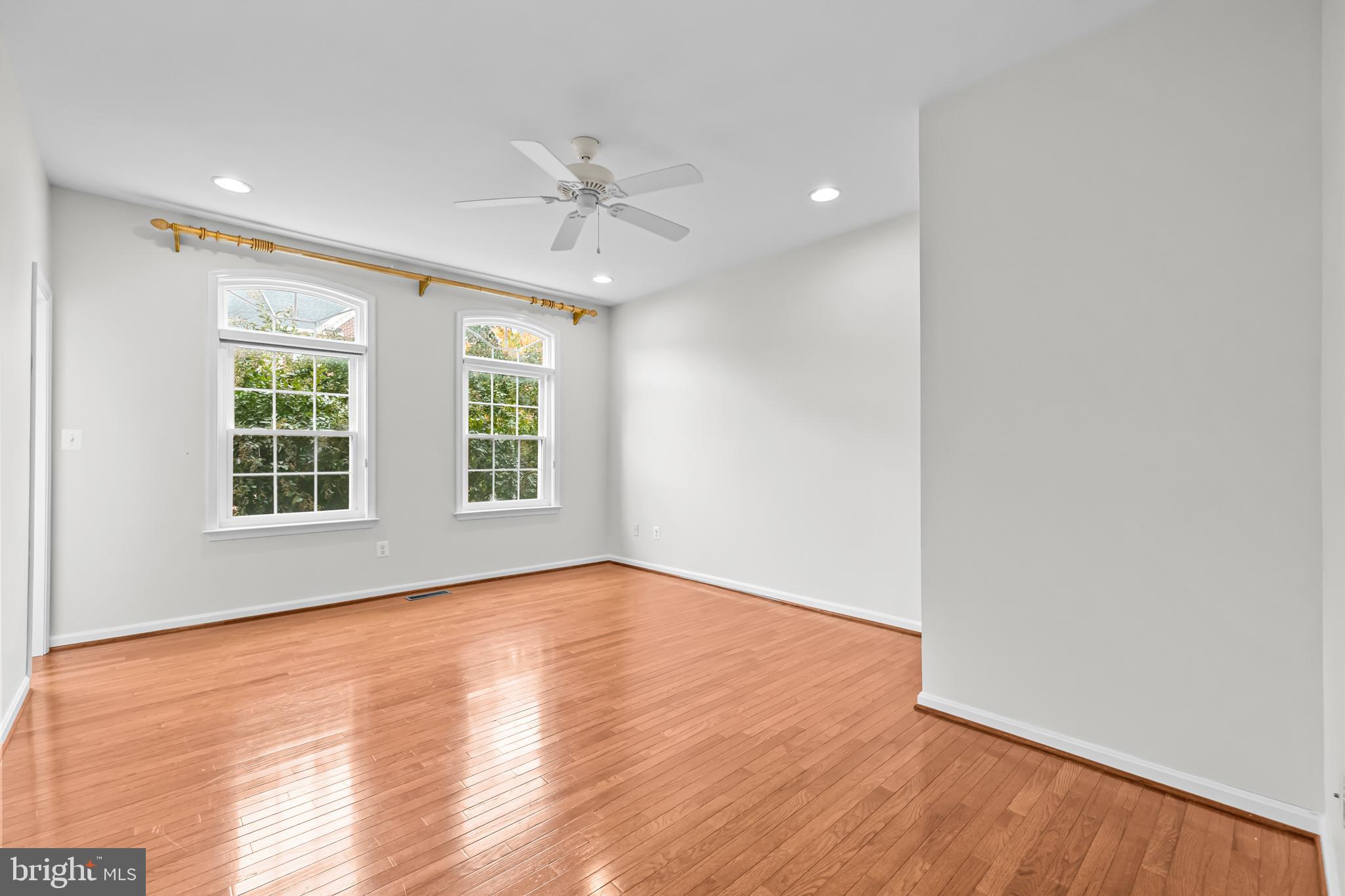 20366 Cloverfield Terrace Sterling, VA 20165 - Photo 23 of 96 a view of an empty room with wooden floor and a window