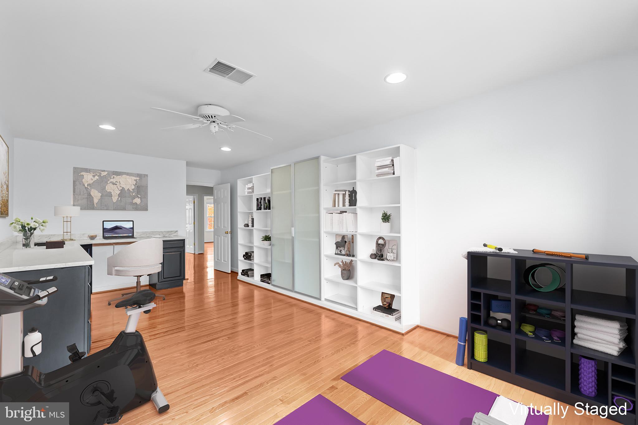 20366 Cloverfield Terrace Sterling, VA 20165 - Photo 49 of 96 a living room with furniture a flat screen tv and a book shelf