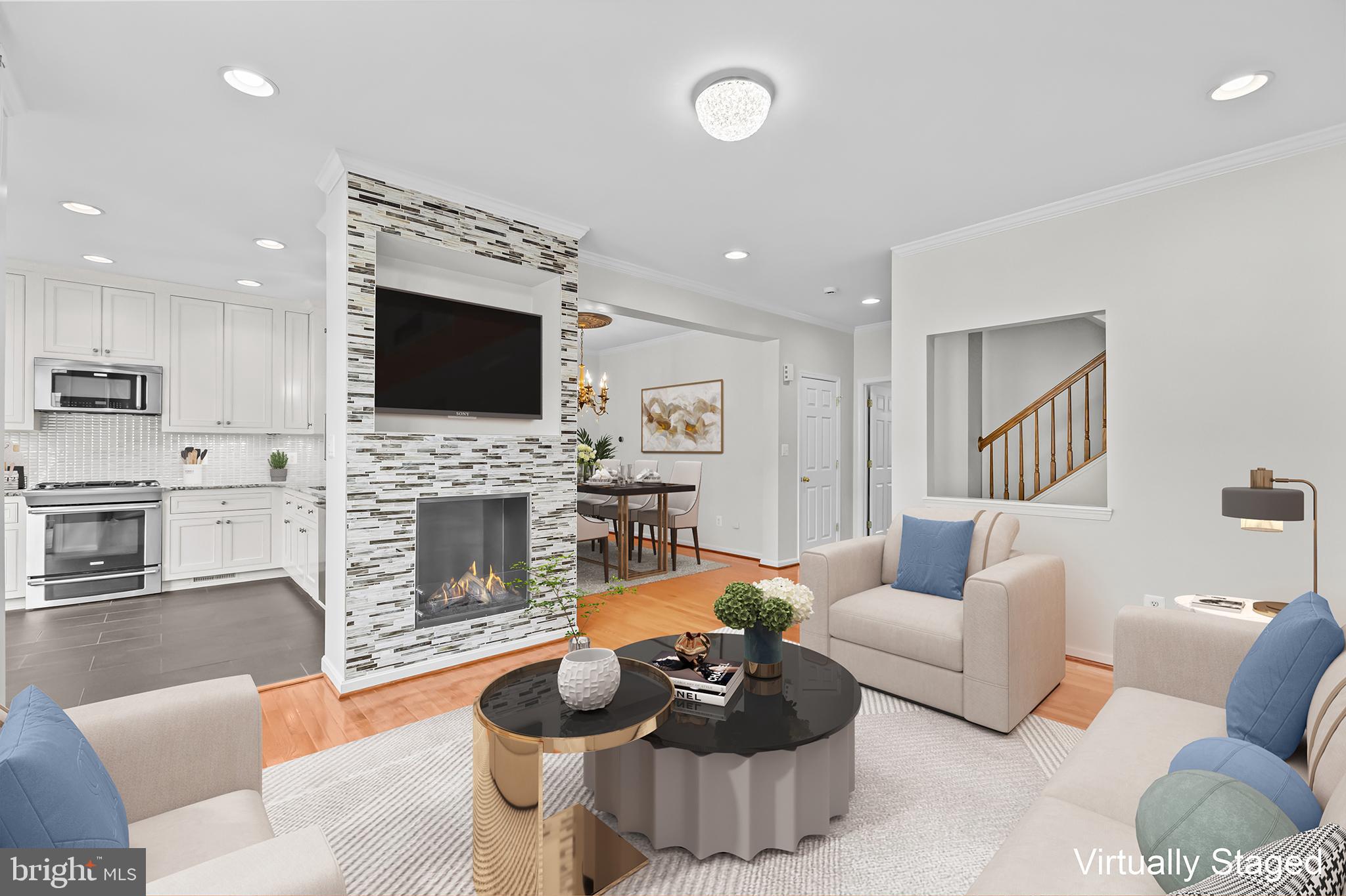 20366 Cloverfield Terrace Sterling, VA 20165 - Photo 5 of 96 a living room with furniture a fireplace and a flat screen tv