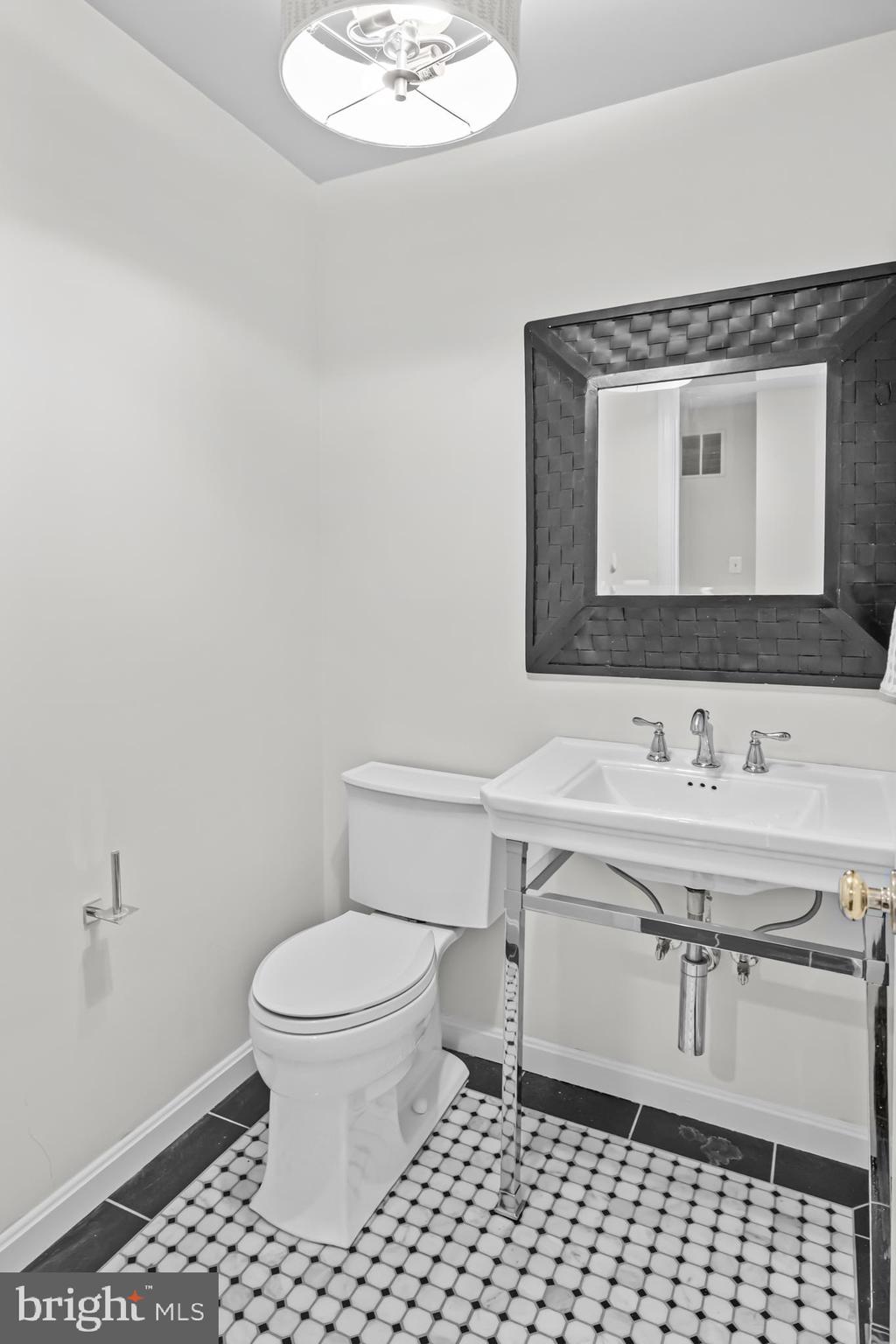 20366 Cloverfield Terrace Sterling, VA 20165 - Photo 65 of 96 a bathroom with a sink toilet and mirror