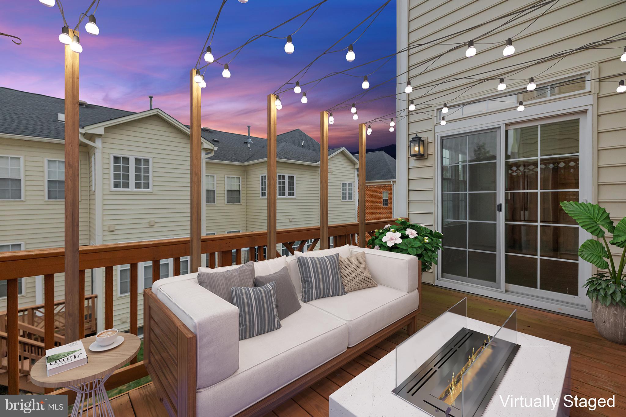 20366 Cloverfield Terrace Sterling, VA 20165 - Photo 67 of 96 a view of a chair and tables in the back yard of the house