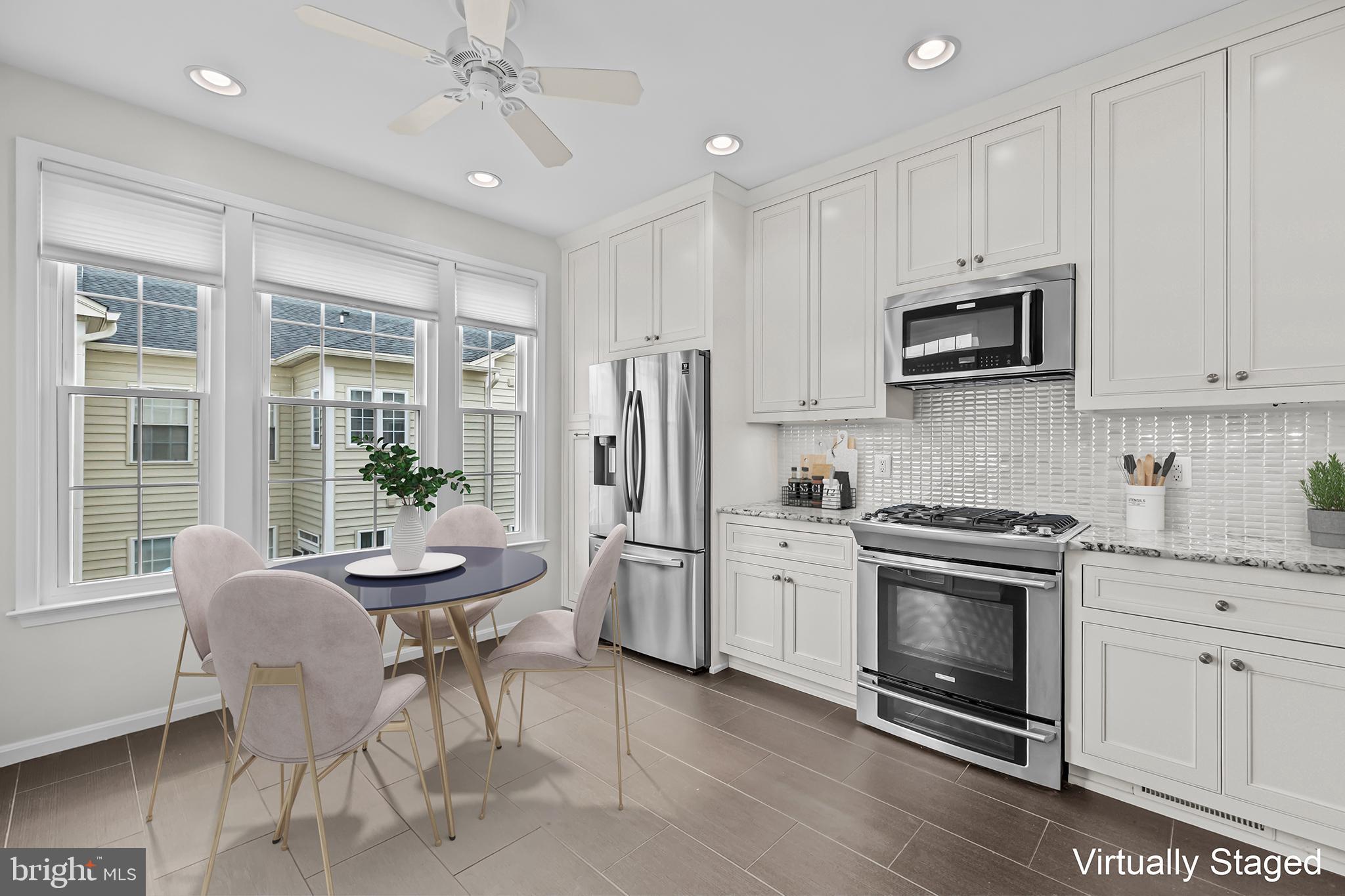 20366 Cloverfield Terrace Sterling, VA 20165 - Photo 8 of 96 a kitchen with stainless steel appliances granite countertop a stove a sink dishwasher a refrigerator and a dining table with wooden floor
