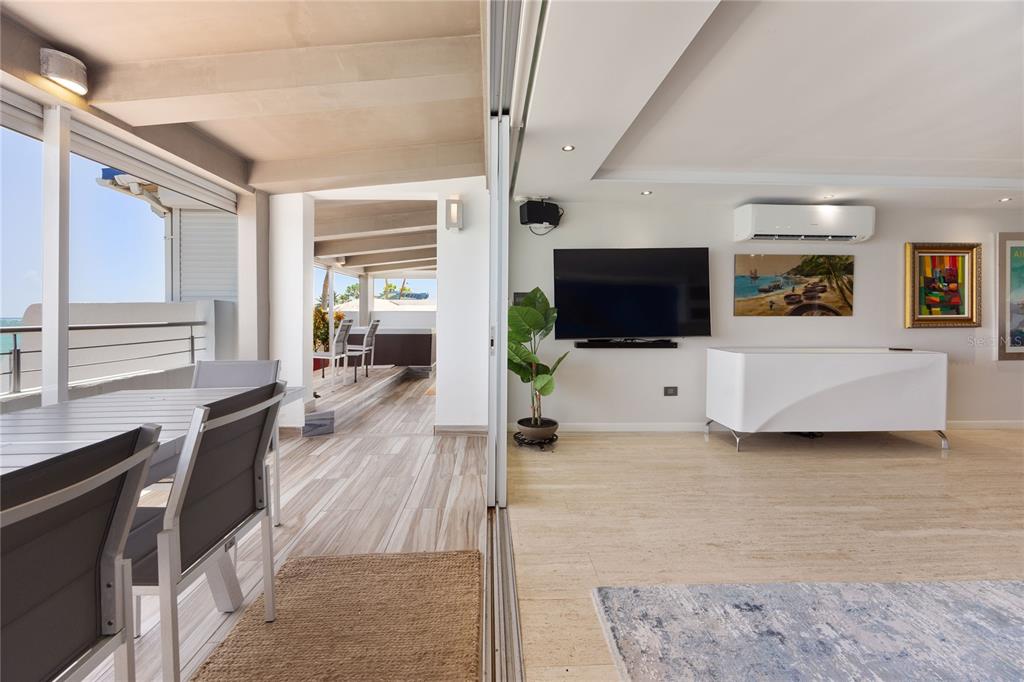 1 Bucaré, Unit 4 San Juan, PR 00913 - Photo 16 of 49 a living room with furniture and a flat screen tv