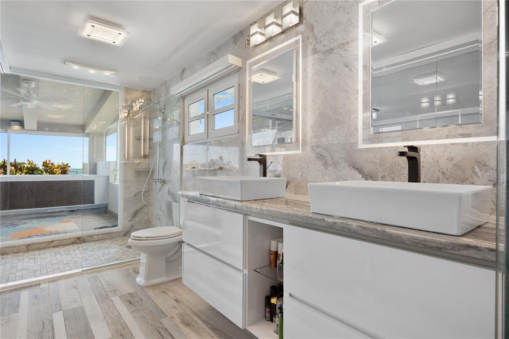 1 Bucaré, Unit 4 San Juan, PR 00913 - Photo 27 of 49 a bathroom with a sink a toilet and a large mirror