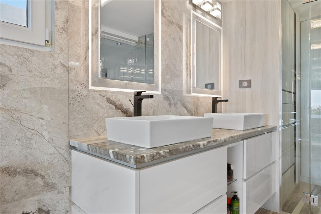 1 Bucaré, Unit 4 San Juan, PR 00913 - Photo 28 of 49 a bathroom with a granite countertop sink and a mirror