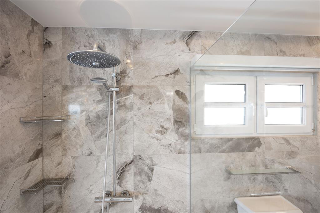 1 Bucaré, Unit 4 San Juan, PR 00913 - Photo 30 of 49 a bathroom with a granite countertop shower and a window