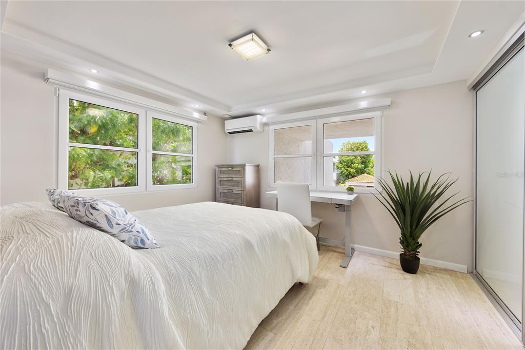 1 Bucaré, Unit 4 San Juan, PR 00913 - Photo 32 of 49 a bedroom with a large bed and a large window