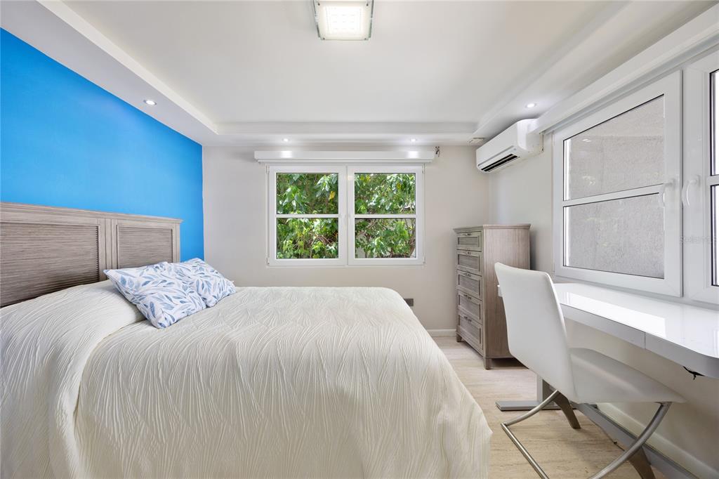 1 Bucaré, Unit 4 San Juan, PR 00913 - Photo 33 of 49 a bedroom with a large bed and a window