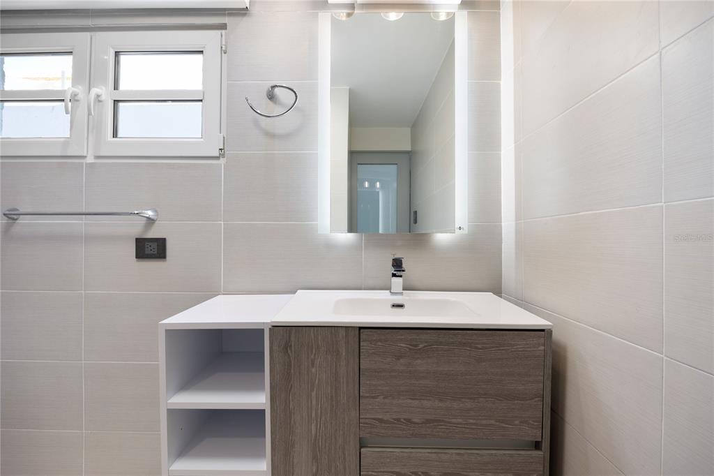 1 Bucaré, Unit 4 San Juan, PR 00913 - Photo 35 of 49 a bathroom with a sink and a mirror