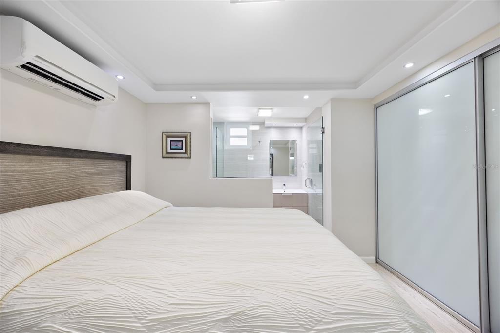 1 Bucaré, Unit 4 San Juan, PR 00913 - Photo 38 of 49 a large white bedroom with a large bed and chandelier