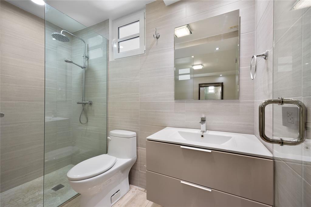 1 Bucaré, Unit 4 San Juan, PR 00913 - Photo 39 of 49 a bathroom with a toilet sink shower and mirror