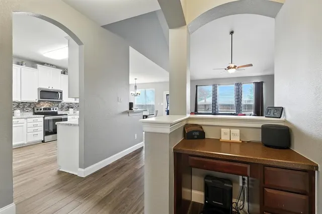 a kitchen with a stove and a wooden floor