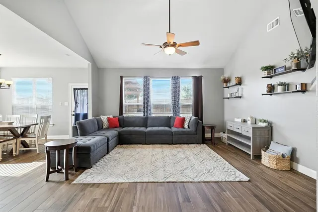 a living room with furniture and wooden floor