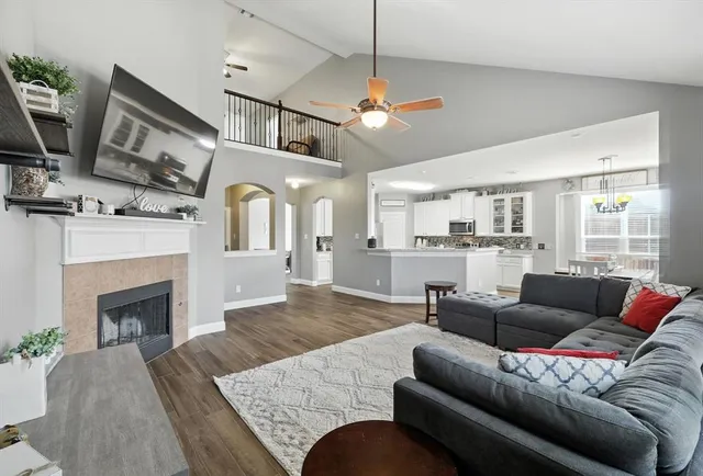 a living room with furniture kitchen view and a fireplace