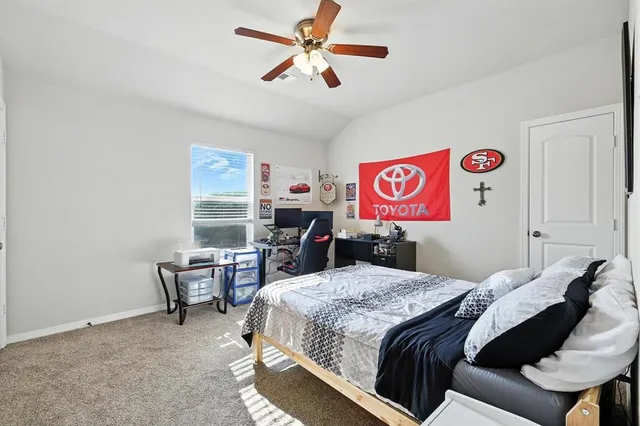 a bedroom with a bed and a desk