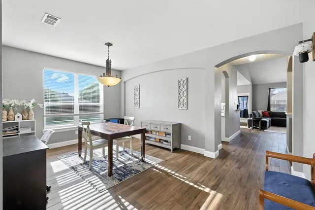 a view of a livingroom with furniture window and wooden floor