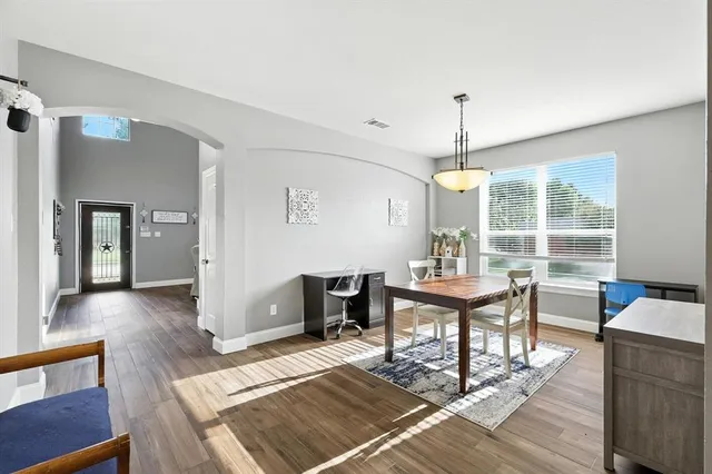 a view of a dining room with furniture window and wooden floor