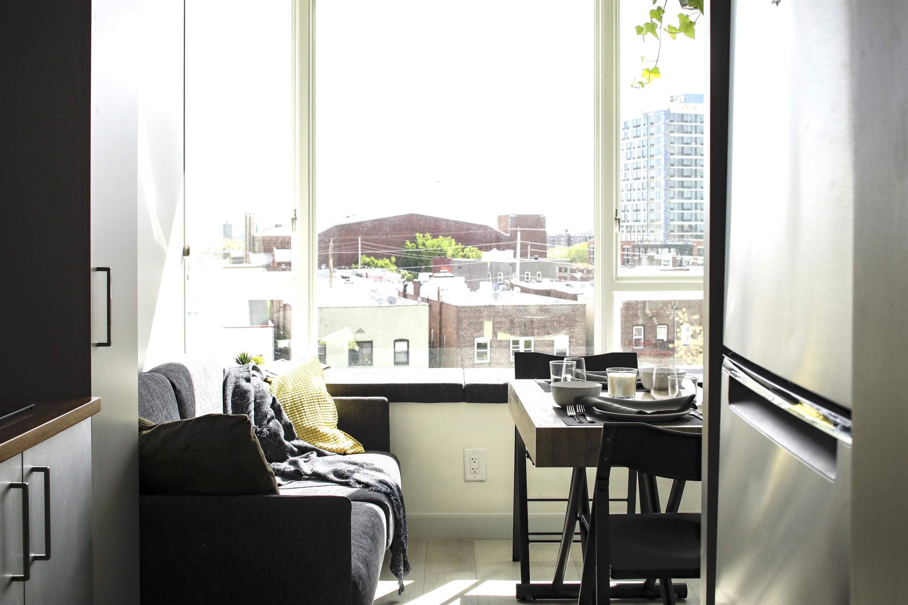 190 Academy Street, Unit 402 Jersey City, NJ 07306 - Photo 6 of 16 a dining room with furniture and a floor to ceiling window