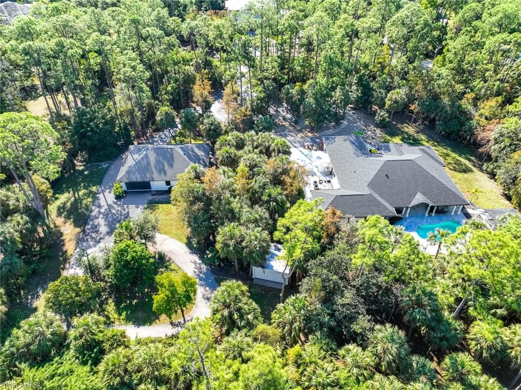 an aerial view of a house with yard and outdoor seating
