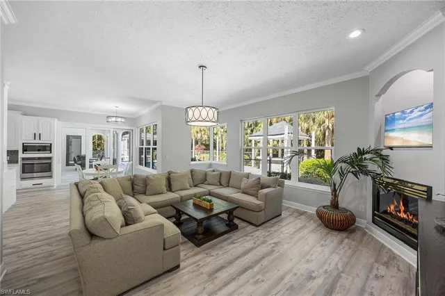 a living room with furniture fireplace and a large window