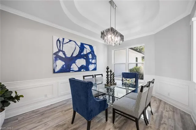 a view of a dining room with furniture wooden floor and chandelier