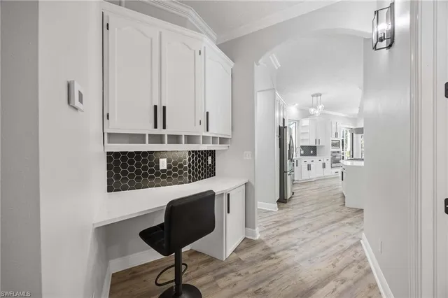 a view of a kitchen with furniture and wooden floor