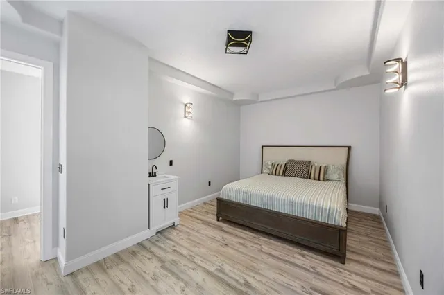 a bedroom with a large bed and a chandelier