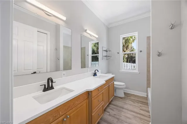 a bathroom with a double vanity sink a mirror and a bathtub