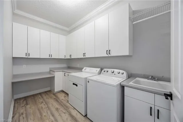 a utility room with sink dryer and washer