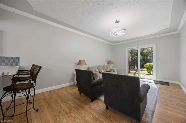 a kitchen with white cabinets and window