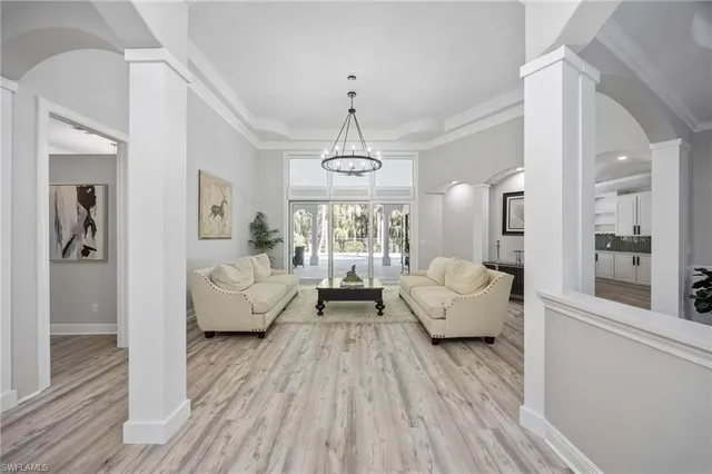 a living room with furniture and a chandelier