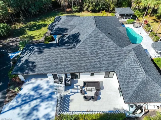 an aerial view of a house with a yard and fountain