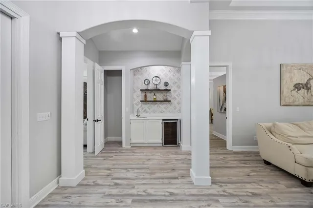 a living room with a fireplace and wooden floor