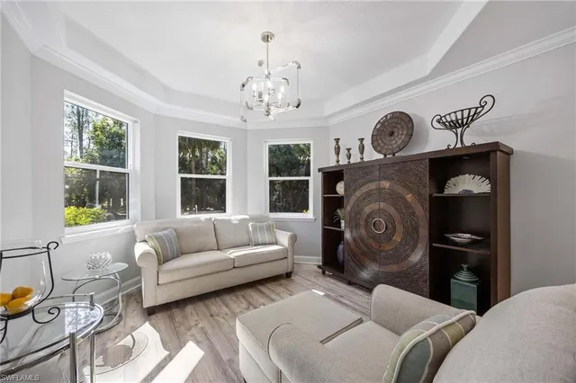 a bedroom with furniture and a large window