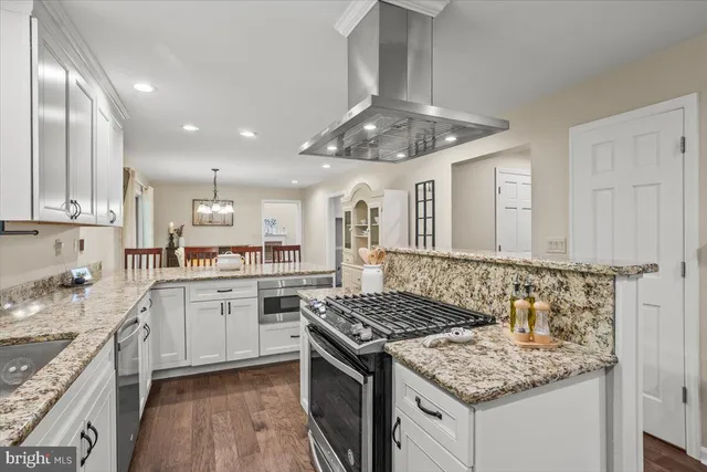 a view of cabinets with stainless steel appliances granite countertop cabinets and a window