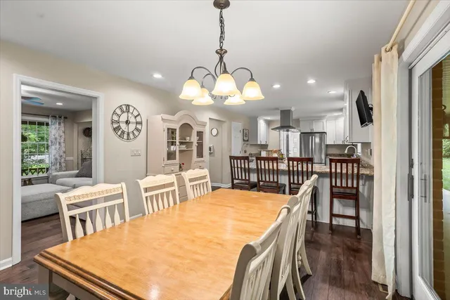 a large kitchen with a table and chairs