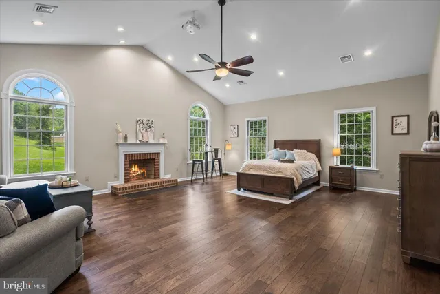 a bedroom with furniture and a fireplace